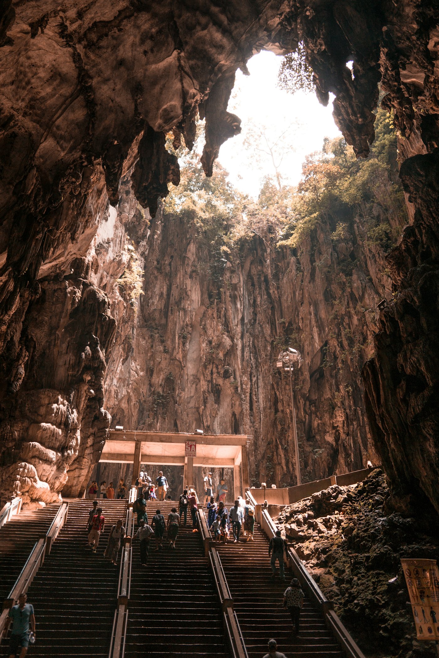 A guided group discovering a cavern beneath the mountain landscape