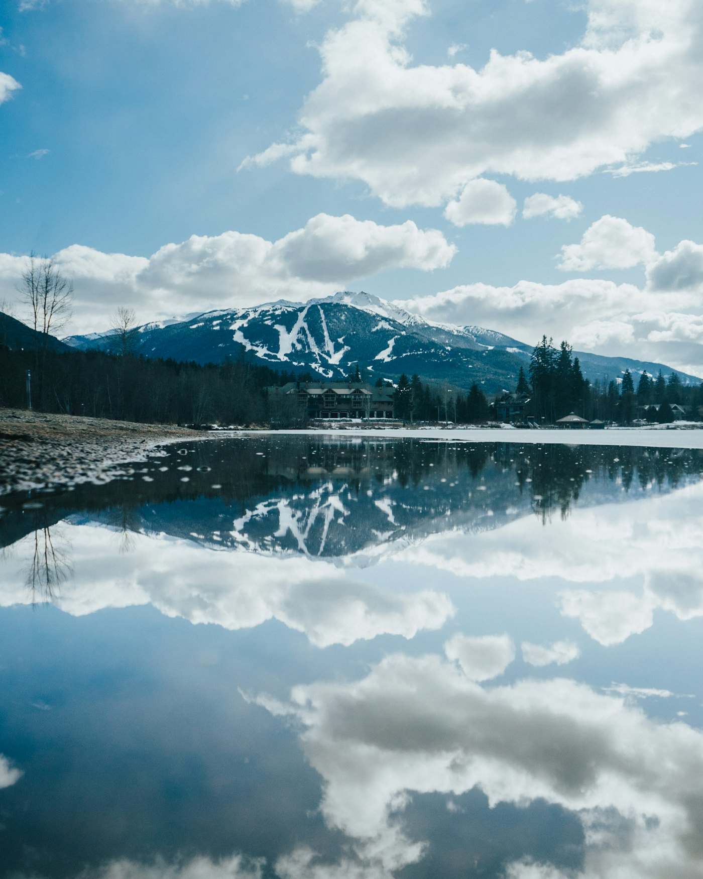 A reflective alpine lake within a national-park landscape